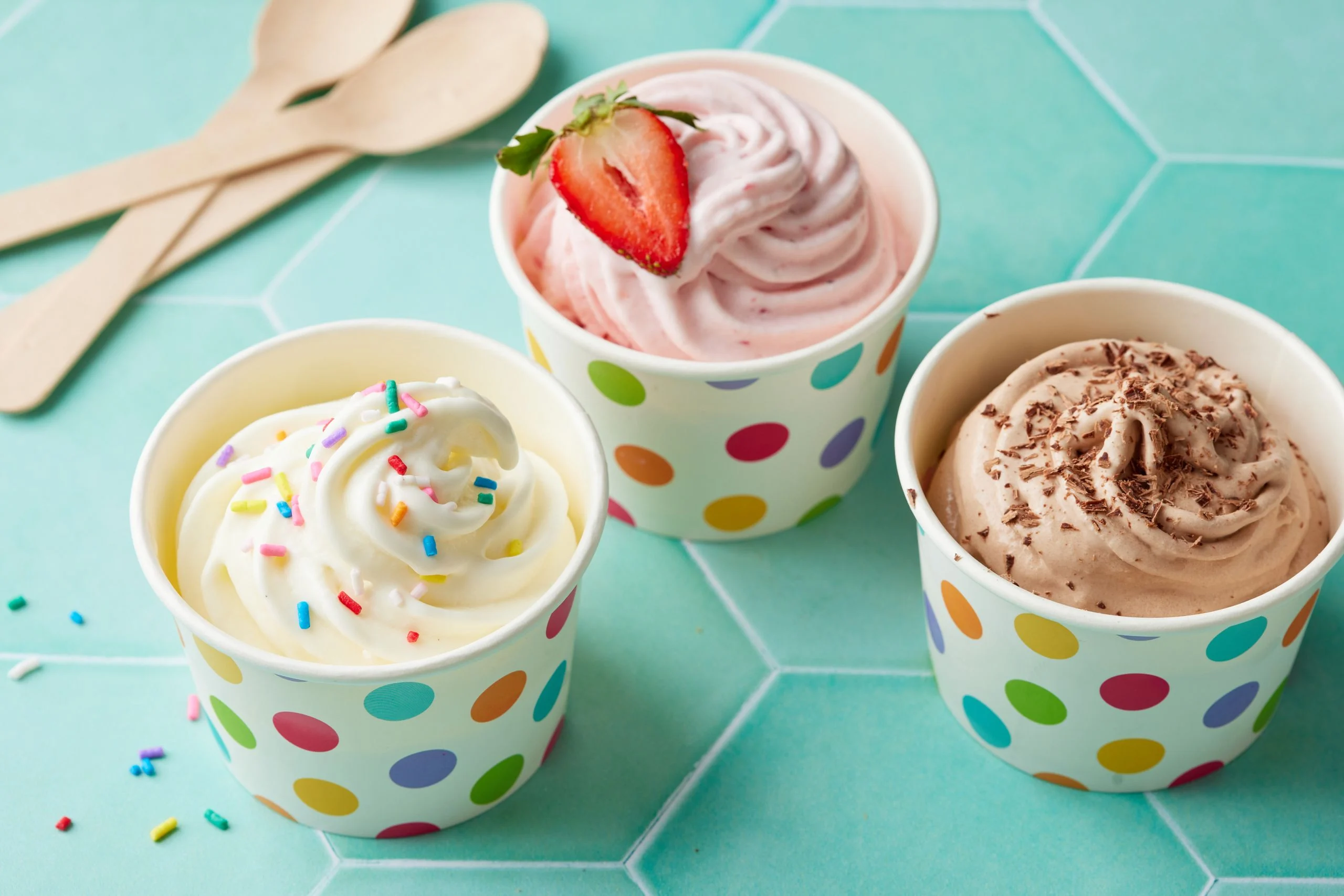 Cups of frozen yogurt with toppings
